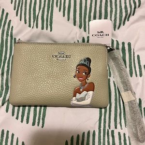 Like new, never been used princess and the frog Wristlet by Coach